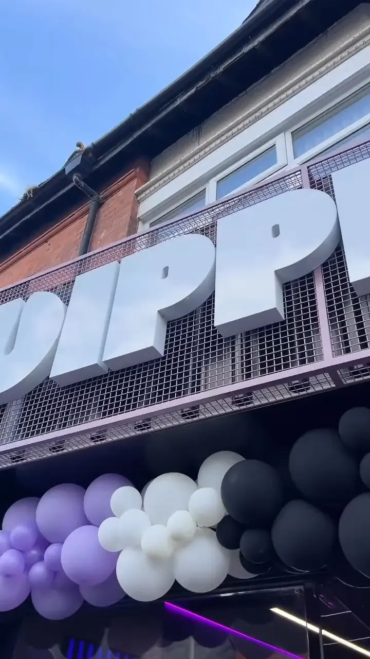 Dippers shop sign with purple balloons on launch day